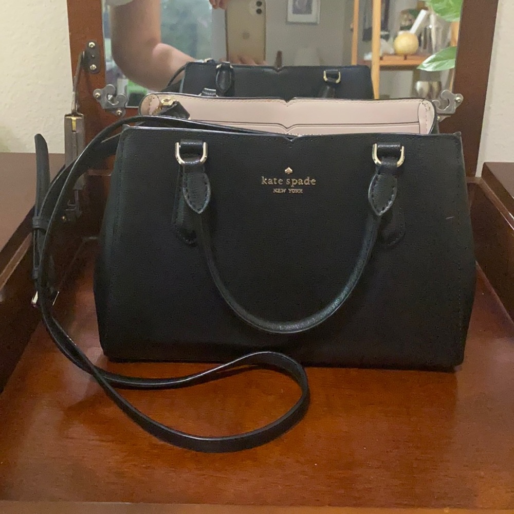 Black Kate Spade handbag with shoulder strap.